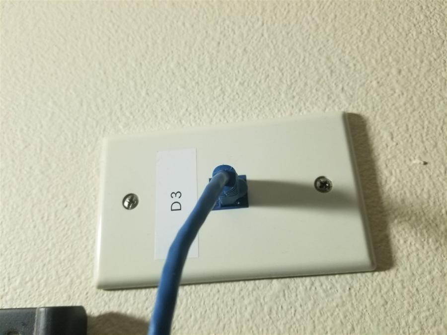 Cat5e drop terminated and labeled at a wall plate